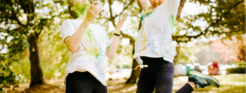 Two girls jumping during the Colour run